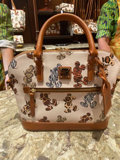Contact information for wirwkonstytucji.pl - Cats 2020 Tote. Dimensions: 11 1/4” H x 14” W x 6 3/4” D. Handle drop: 10 1/2”. Reigning Cats and Dogs Cat Tote (back) Meow! This adorable tote by Dooney & Bourke is simply purrfect for cat-loving Disney fans everywhere. The front and back of this spacious bag features a clowder of familiar fluffy film felines.